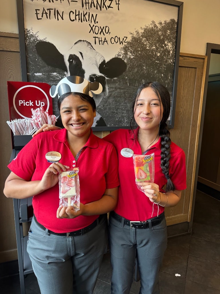 Chick-fil-A employees smiling and holding La Michoacana paletas — community love Gainesville GA